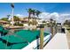 Beautiful waterfront home with private dock and boat lift on a sunny day with blue skies and fluffy white clouds at 1541 Shelburne Ln, Sarasota, FL 34231