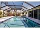 Beautiful pool with a screened enclosure and tile trim at 1541 Shelburne Ln, Sarasota, FL 34231