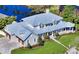 Stunning aerial view of house featuring a manicured lawn, private pond, and a 3-car garage at 1543 Eastbrook Dr, Sarasota, FL 34231