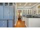 A bar area with blue cabinets, hardwood floors, and white countertops at 1543 Eastbrook Dr, Sarasota, FL 34231