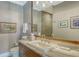 Neutral bathroom with a decorative mirror, beautiful counters, and tile flooring, and a toilet at 1543 Eastbrook Dr, Sarasota, FL 34231