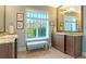 Bathroom with double vanity, modern fixtures, and bench seating below the large window at 1543 Eastbrook Dr, Sarasota, FL 34231