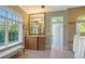 Bright bathroom with natural light, vanity, mirror, and neutral walls complemented by tile floors at 1543 Eastbrook Dr, Sarasota, FL 34231