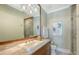 Bright bathroom features a large mirror, walk-in shower, and neutral color palette at 1543 Eastbrook Dr, Sarasota, FL 34231