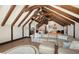 Spacious bonus room with exposed beam ceiling, comfortable seating, and wet bar at 1543 Eastbrook Dr, Sarasota, FL 34231