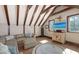 Bonus room with exposed beam ceiling, comfortable seating, and built in cabinets and furnishings at 1543 Eastbrook Dr, Sarasota, FL 34231