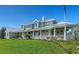A charming single-Gathering home shows off a metal roof, gracious front porch, and meticulously landscaped yard at 1543 Eastbrook Dr, Sarasota, FL 34231