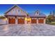 Charming home featuring a four-car garage, stone driveway, and well-lit exterior at 1543 Eastbrook Dr, Sarasota, FL 34231
