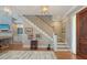 Inviting foyer with hardwood floors, a staircase, and a glimpse into the living area at 1543 Eastbrook Dr, Sarasota, FL 34231