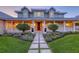 A stunning home exhibits an attractive front entrance with stone walkway and manicured garden at 1543 Eastbrook Dr, Sarasota, FL 34231