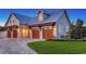 A charming three-car garage is adorned with wooden doors and pergola details, complemented by lush green landscaping at 1543 Eastbrook Dr, Sarasota, FL 34231