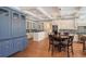 Bright kitchen with a breakfast nook, stainless steel appliances, hardwood floors, and custom blue cabinets at 1543 Eastbrook Dr, Sarasota, FL 34231