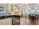 An open concept kitchen with black countertops, stainless steel appliances, and wood floors at 1543 Eastbrook Dr, Sarasota, FL 34231