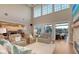Open living room with high ceilings, hardwood floors, and views of the pool and waterway through glass doors at 1543 Eastbrook Dr, Sarasota, FL 34231