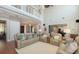 Spacious living room with hardwood floors, high ceilings, second story overlook, and neutral colored decor at 1543 Eastbrook Dr, Sarasota, FL 34231