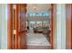 A glimpse into the living room through a double-door entrance shows a luxurious interior with soaring ceilings at 1543 Eastbrook Dr, Sarasota, FL 34231
