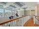 Upstairs loft featuring coffered ceilings, lots of windows, and hardwood floors and railing at 1543 Eastbrook Dr, Sarasota, FL 34231