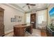 Home office featuring a large desk, hardwood floors, soft natural light and ample display shelving at 1543 Eastbrook Dr, Sarasota, FL 34231