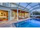 Rear exterior of house showing pool, outdoor seating under screened enclosure at 1543 Eastbrook Dr, Sarasota, FL 34231