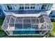Aerial view of a screened-in pool with a patio featuring outdoor seating and lounge chairs at 1543 Eastbrook Dr, Sarasota, FL 34231