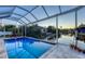 Beautiful screened-in pool area with scenic views of the water, perfect for outdoor relaxation and enjoyment at 1543 Eastbrook Dr, Sarasota, FL 34231