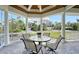A relaxing outdoor area provides a table with seating for four and views of the yard at 1543 Eastbrook Dr, Sarasota, FL 34231
