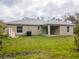 Backyard with a spacious lawn and covered patio at 1620 Geranium Ave, North Port, FL 34288