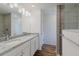 Bright bathroom featuring a double vanity with granite countertop and tiled shower at 1620 Geranium Ave, North Port, FL 34288