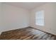 Cozy bedroom with wood-look floors, white walls, and a bright window at 1620 Geranium Ave, North Port, FL 34288