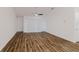 Bright living room featuring wood-look floors, a modern ceiling fan, and a sliding glass door to the yard at 1620 Geranium Ave, North Port, FL 34288