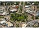 Overhead view of a community showcasing a roundabout, mature trees, and charming architecture at 1631 Loma Linda St, Sarasota, FL 34239