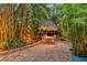 Inviting backyard with patio and thatched umbrella shaded dining set at 1631 Loma Linda St, Sarasota, FL 34239