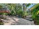 Backyard features mature tropical landscaping, a hot tub, and a patio area at 1631 Loma Linda St, Sarasota, FL 34239