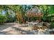 Charming backyard features a thatched umbrella and white wrought-iron dining set at 1631 Loma Linda St, Sarasota, FL 34239