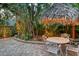Picturesque backyard featuring a thatched umbrella with dining set at 1631 Loma Linda St, Sarasota, FL 34239