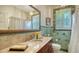 Bathroom featuring green tile accents, a marble vanity, and a large mirror at 1631 Loma Linda St, Sarasota, FL 34239