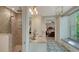 Bathroom with walk-in shower, patterned tile floor, vanity with sink and a window providing natural light at 1631 Loma Linda St, Sarasota, FL 34239
