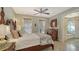 This bedroom features a decorative ceiling fan and a four-poster bed, and a hall that leads into another room at 1631 Loma Linda St, Sarasota, FL 34239