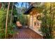 Charming exterior with relaxing deck area surrounded by lush greenery at 1631 Loma Linda St, Sarasota, FL 34239