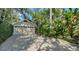 Detached garage with driveway and mature landscaping adding to the curb appeal at 1631 Loma Linda St, Sarasota, FL 34239