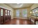 Inviting entryway featuring a wood door with sidelights, hardwood floors, and a decorative table with lamps at 1631 Loma Linda St, Sarasota, FL 34239