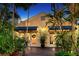 Charming home exterior with French doors and beautiful tropical landscaping at 1631 Loma Linda St, Sarasota, FL 34239