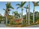 Charming yellow home surrounded by lush tropical landscaping and towering palm trees at 1631 Loma Linda St, Sarasota, FL 34239