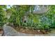 Charming home exterior with vibrant mural, lush tropical landscaping, and brick pathway at 1631 Loma Linda St, Sarasota, FL 34239