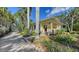 Beautiful vintage home with lush landscaping, a brick driveway, and a detached garage at 1631 Loma Linda St, Sarasota, FL 34239