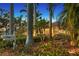 Exterior view of vintage home with mailbox, mature trees, and flowering bushes at 1631 Loma Linda St, Sarasota, FL 34239