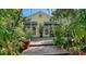 Charming home exterior with French doors and lovely tropical landscaping at 1631 Loma Linda St, Sarasota, FL 34239
