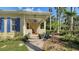 Charming front porch showcasing a swing, plants, and blue shutters, enhancing the curb appeal at 1631 Loma Linda St, Sarasota, FL 34239