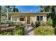 Inviting front porch with a cozy swing and well-maintained landscaping surrounding the entrance at 1631 Loma Linda St, Sarasota, FL 34239