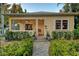 Inviting front porch with a porch swing, plants, and stone pathway at 1631 Loma Linda St, Sarasota, FL 34239
